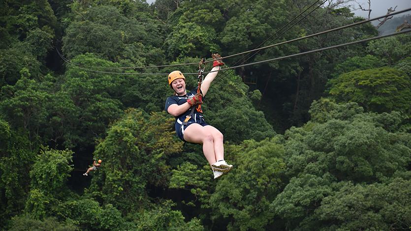 Image of Jenna Jedlicka on a zip line during the recreational day of the Costa Rica trip.